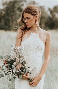 a woman in a white dress holding a bouquet