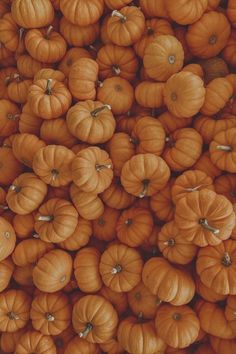 many small pumpkins are stacked together in the same pattern as one large group of smaller ones