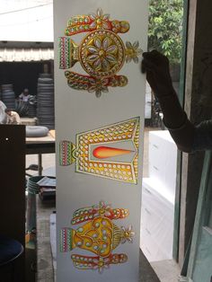 an image of stickers on the side of a glass door that is being painted