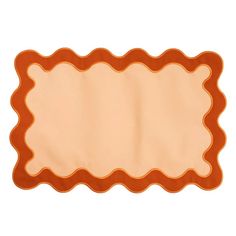 an orange and beige place mat with scalloped edges on a white background,