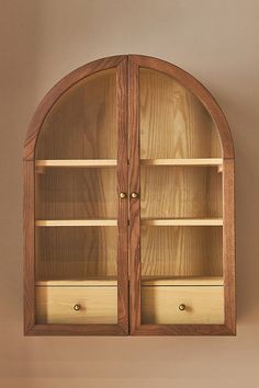 an arched wooden shelf with two drawers