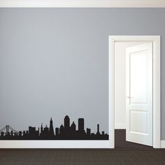 an open door in a room with a city skyline wall decal