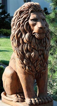 a statue of a lion sitting in front of a house