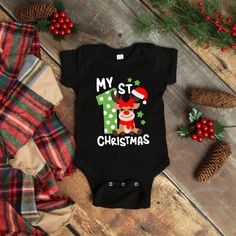 Everyone loves babies 1st Christmas; this onesie® is so cute and will be the talk of any holiday event on your baby boy or baby girl. Onesie® comes in four colors Black, Gray, Red & White and sizes of your choice. We use high quality, soft flex vinyl which not only creates a sharp, vivid graphic but will never look "faded" or “washed out” like some inks commonly do. Processing time is 2-4 days, delivery will depend on your choice at checkout First Class Mail 5-7 days, Priority Mail 2-4 days & Pr Christmas Onsies, Reindeer Onesie, My 1st Christmas, Black Onesie, Christmas Onesie, Twin Outfits, Baby Boy Onesies, Holiday Baby, Funny Outfits