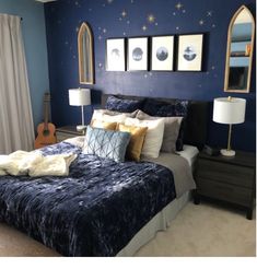 a bedroom with blue walls and gold accents