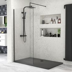 a bathroom with a walk in shower and shelves on the wall