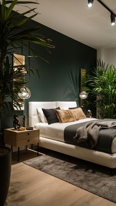 a bedroom with green walls and white bedding, potted plants on the side