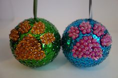 two ornaments with beads on them sitting next to each other