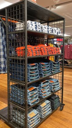 a metal rack filled with lots of blue and orange plates on top of wooden floors