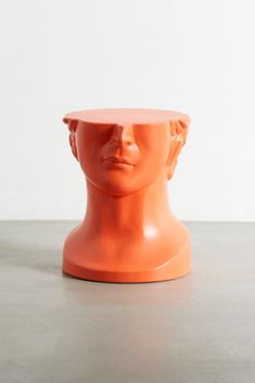 an orange plastic head on a table