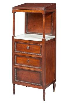 a wooden cabinet with two drawers and marble top inlays on the bottom shelf