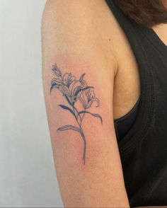 a woman with a flower tattoo on her arm