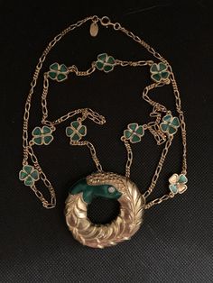 Lanvin's designer necklace consisting of clovers measuring 1.4 cm enamelled in green color and a gold metal medallion and crystals measuring 5 cmSmall imperfections is a vintage product Green Medallion Necklace For Formal Occasions, Vintage Green Long Necklace, Formal Green Locket Necklace, Vintage Green Necklace With Chain, Vintage Yellow Gold Enamel Necklace, Vintage Green Jewelry With Chain, Victorian Gold Enamel Necklace, Victorian Green Medallion Jewelry, Luxury Green Medallion Necklace