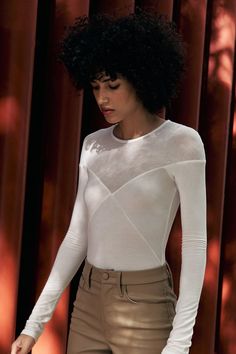 When it comes to second-skin staples that fit and flatter, our Lara Bodysuit checks all the boxes. She's a versatile and modern long-sleeve bodysuit with an individual spirit. Her bodice has been contoured using both sheer and opaque high-stretch European jersey fabrics, with our sheer jersey up top creating a v-neck illusion. Visible seaming and extra-long sleeves blend elegance and edge in this women’s bodysuit. This one-piece features a snap button closure at the bottom for easy on/off.[SPLIT Chic Bodysuit With Sheer Long Sleeves, Stretch Bodysuit With Sheer Long Sleeves, Sheer Fitted Bodysuit For Fall, Fitted Sheer Bodysuit For Fall, White Fitted Long Sleeve Bodysuit, Sheer Stretch Long Sleeve Bodysuit, High Stretch Bodysuit With Long Mesh Sleeves, Sheer Long Sleeve High Stretch Bodysuit, High Stretch Long Sleeve Bodysuit With Sheer Sleeves