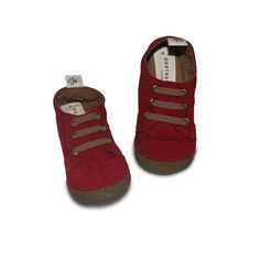 Looking for the perfect shoe for your baby or toddler to learn to walk in? Maybe they're still crawling a bit or if you're lucky, even doing the occasional run! That's ok, we've got those tiny little feet covered, whatever they're up to. With a cranberry (a brighter burgundy) cotton canvas upper and a feather light, brown, flexible rubber sole, this modern sneaker has your little guy covered. Like all Gertrude and the King shoes, they're machine washable (Hooray and the pull tag on the heel make Best Baby Shoes, King Shoes, Walking Barefoot, Walker Shoes, Baby Sneakers, Crib Shoes, Feather Light, Elastic Laces, Perfect Shoes