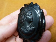 Vintage Woman wearing tiara Bakelite black mourning oval shaped CAMEO pin brooch c1557 Antique Black Brooches For Formal Occasions, Antique Black Brooch For Wedding, Formal Black Cameo Jewelry, Antique Black Wedding Brooches, Antique Black Wedding Brooch, Luxury Oval Cameo Brooch, Elegant Black Cameo Brooches, Yellow Gold Oval Cameo Brooch, Victorian Black Cameo Brooches