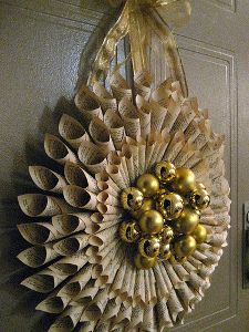 an ornament hanging on the front door with gold ornaments in it's center