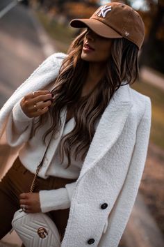 Fashion blogger mia mia mine wears a gucci crossbody bag outfit with an ivory coat and brown coated jeans. click through to see more casual weekend outfits for winter, how to wear a baseball cap, jeans and sneakers outfit, and cozy cardigan outfits. #casualootd #gucci #womensfashion #outfitinspo Lisa Vidal, Cap Outfits For Women, Winter Cardigan Outfit, White Coats, Baseball Cap Outfit, Coated Jeans, Cap Outfit, Looks Pinterest