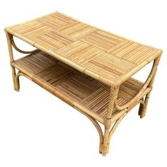 a coffee table made out of wicker with two shelves on the top and bottom