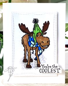 a card with an image of a moose wearing a hat and scarf on it's head