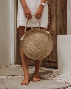 Experience the epitome of eco-conscious elegance with our Natural Grass Tote Bag, thoughtfully handcrafted to seamlessly house all your essentials while exuding an airy and environmentally-conscious charm. Crafted from authentic Balinese grass, each piece carries the essence of traditional island craftsmanship. Whether you're embarking on weekend getaways or leisurely strolls, this generously sized, round tote bag provides ample space for your belongings, ensuring you're always well-prepared in an eco-friendly manner. How it's Made Did you know it takes ONE MONTH to make one Rattan bag? That's because each of our Bali Bags is handcrafted from start to finish by artisans in Bali. ◖Made from a vine native to the volcanic foothills on the island of Bali. First, the stems are braided to create Straw Beach Tote, Round Straw Bag, Wicker Purse, Wicker Bags, Rattan Bag, Summer Bag, Vegan Bags, Environmentally Conscious, Perfect Tote Bag