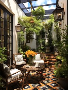 a patio with chairs, tables and potted plants