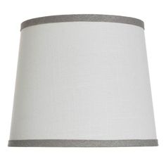 a white lamp with grey trim on the bottom and side of the lampshade