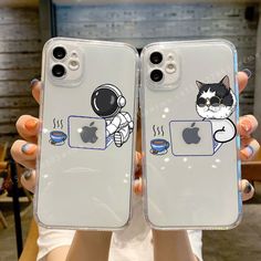 two people holding up their iphone cases with an image of a cat and astronaut on them