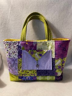 This handcrafted bag will be your go-to bag! whether you are using as a handbag or a carryall bag, it will be perfect. It is bright and colorful with plenty of pockets and a snap closure at the top. there is one pocket on the outside finished with a unique charm to match. There are various designs offered, each in a different size: Purple: 16" wide, 11" high and 4" deep Pink: 15'' wide, 10.5'' high and 3'' deep Custom bags can be ordered in different color variations. Contact our shop and we can Purple Bag With Zipper Pocket For Everyday Use, Purple Satchel Bag With Pockets, Purple Everyday Bags With Pockets, Purple Rectangular Bag With Zipper Pocket, Everyday Purple Bag With Pockets, Purple Bags With Pockets For Daily Use, Purple Rectangular Bag With Pockets, Multicolor Bags With Pockets For Daily Use, Square Purple Satchel For Everyday Use