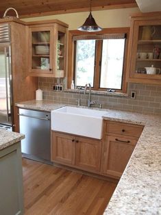 a kitchen with wooden cabinets and granite counter tops