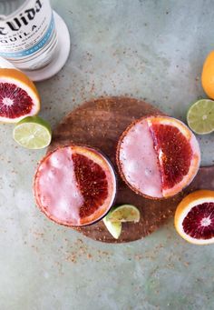 grapefruit margaritas on a cutting board with lime slices