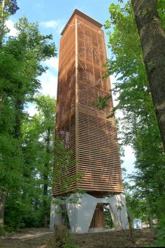 a tall wooden structure sitting in the middle of a forest