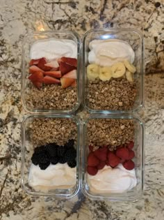 four glass containers filled with different types of food on top of a marble countertop