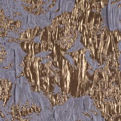 an image of gold and blue fabric with metallic foil on it's surface, as well as the background