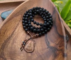 "A NEW BEGINNING Buddhist Mala Necklace Matte Natural Black Onyx Mala Beads 108 * Ethically-Sourced Gemstone Artisan Buddha Mala NecklaceMeditation Gift Grounding Mala Natural, ethically-sourced Gemstones: BLACK ONYX Courage, Strength, Resiliency, Release of the Old & New Beginnings 8mm Ethically-Sourced Matte Black Onyx 108 beads Vintage Copper Buddhist Amulet, Made in Thailand, Blessed in Bhutan Fair-Trade + Recycled copper + brass bead details, handcrafted in Ethiopia This mala features 1 Spiritual Black Beaded Necklaces, Black Spiritual Beaded Necklaces, Handmade Black Mala For Meditation, Hand-strung Black Mala For Meditation, Black Hand-strung Mala For Meditation, Spiritual Black Beaded Necklaces For Meditation, Handmade Black Mala As Gift, Onyx Bead Necklaces For Meditation, Onyx Beaded Necklaces For Meditation