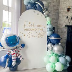 an astronaut themed birthday party with balloons and decorations