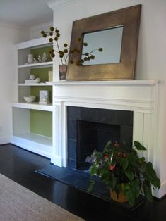 a living room filled with furniture and a fire place under a mirror on top of a mantle