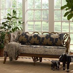 a living room scene with focus on the couch and two zebra figurines in front