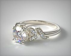 an engagement ring with a large diamond in the center and two smaller diamonds on each side