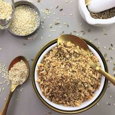 a bowl filled with oatmeal next to two measuring spoons on top of a table