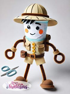 a paper doll with a hat and some scissors