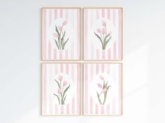 four pink and white flowers are on the wall next to each other, with stripes in the background