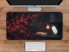 a computer desk with a keyboard, mouse and book on it next to a monitor