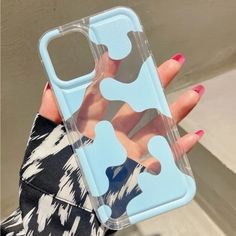 a woman holding up her phone case with an image of a hand on the back