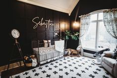 a baby's room is decorated in black and white