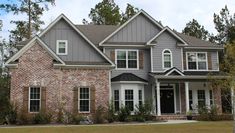 a large brick house with lots of windows