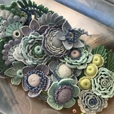 some crocheted flowers are sitting on a table