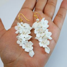 New to our Millennium Bride Collection These Beautiful Romantic WHITE FLOWER PETALS BRIDAL EARRINGS are made of very fine quality of beautifully made Ceramic flowers for your special day! Even we have hard time taking pictures because of their shine 😄 so we want to shine our brides on their special days. The material used in these earrings are free from Lead, Nickel, Cadmium so it will not give you any skin irritation and environment friendly too.. they measure about 7 inches long 3 inches wide White Flower-shaped Pearl Earrings For Anniversary, White Flower Pearl Earrings For Anniversary, White Flower-shaped Cluster Earrings For Anniversary, White Flower-shaped Cluster Earrings For Gifts, White Flower Decorated Earrings For Anniversary, White Earrings With 3d Flowers For Anniversary, White Flower Earrings For Anniversary, White Flower Cluster Earrings, White Cluster Flower-shaped Earrings