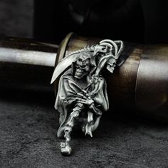 a ring with a skeleton holding a knife