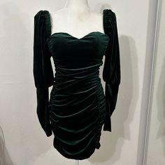 a green dress on a mannequin dummy